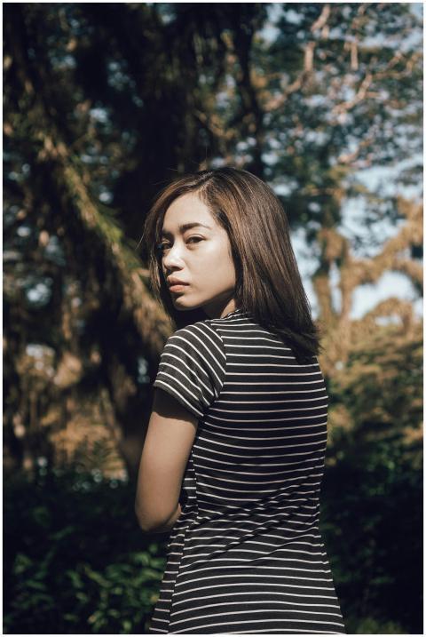 Portrait of a young woman in a striped shirt outdo