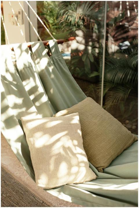A relaxing hammock with cushions, bathed in natura