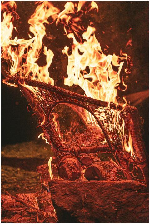 A wicker chair engulfed in flames during a fire at