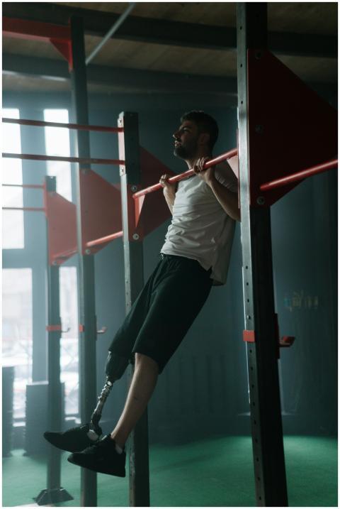 A determined man with prosthetic leg working out o