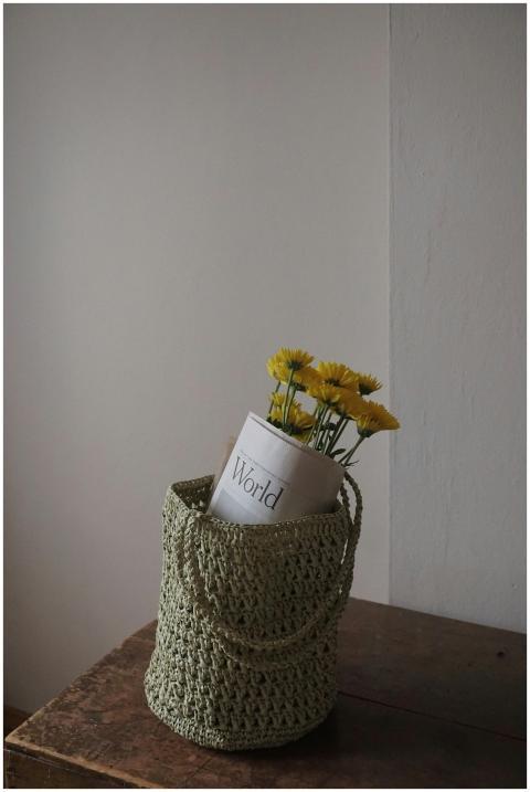 Photograph of a woven green basket containing yell