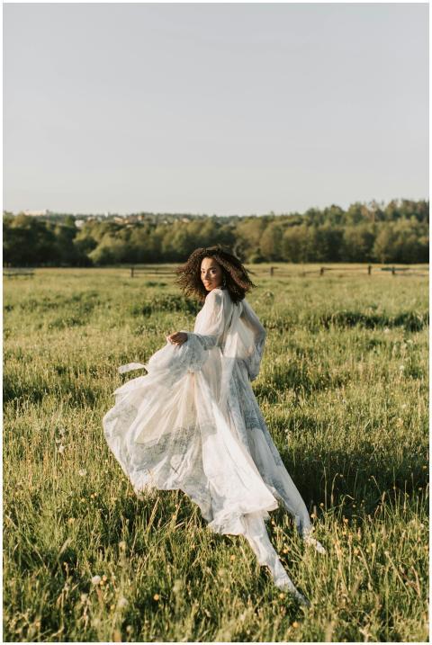 Beautiful woman in a white dress posing in a lush