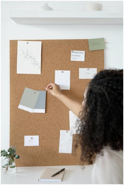 A woman arranges a mood board with design samples