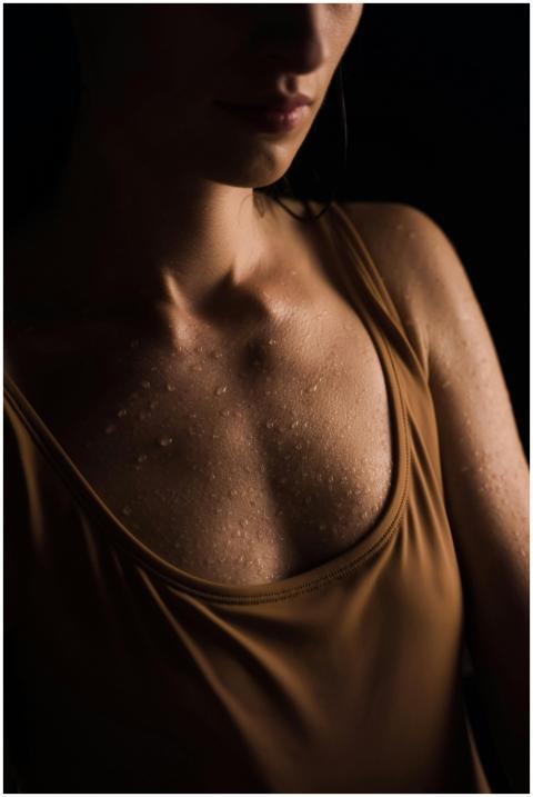 Close-up shot of a woman in a brown tank top, emph