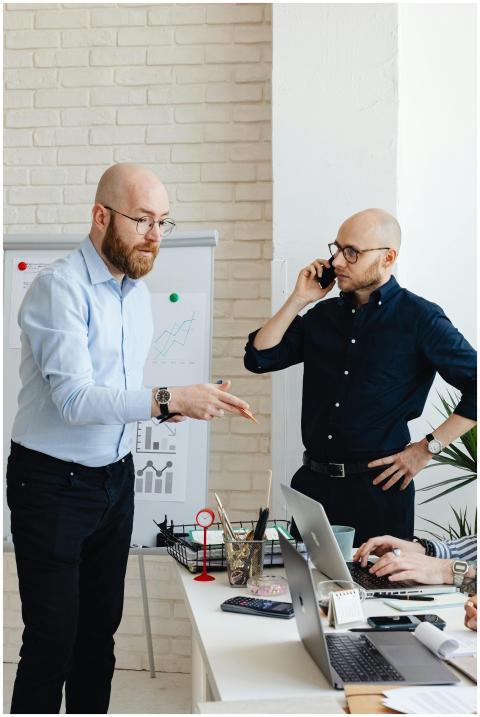 Colleagues in corporate attire discussing work at