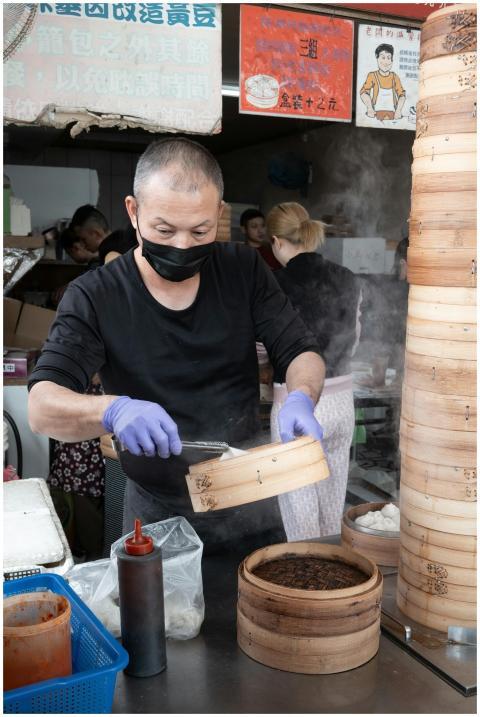 A vendor prepares authentic dim sum in a bustling