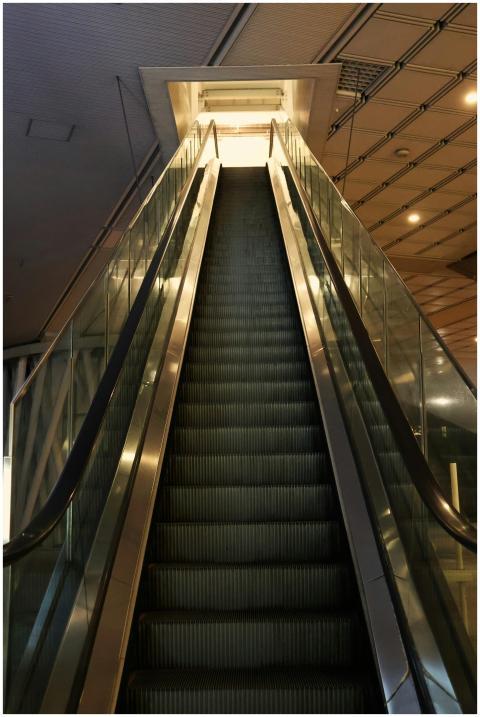 A dramatic upward view of an indoor escalator capt