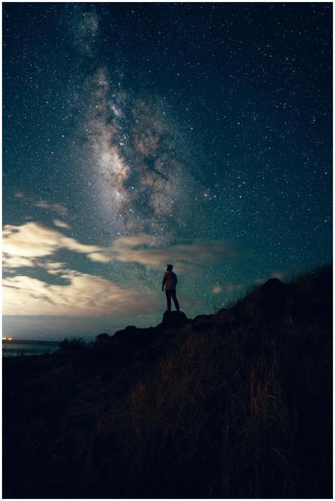 Silhouette of a person under a starry night sky an