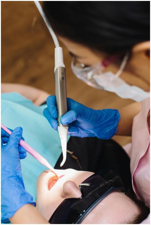 A dentist performs a procedure using modern dental