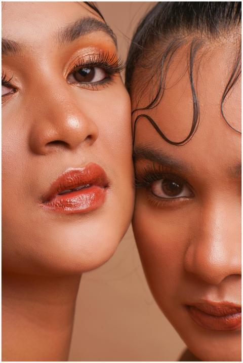 Intimate close-up of two women with striking eye m