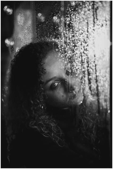 A dramatic black and white portrait of a woman loo