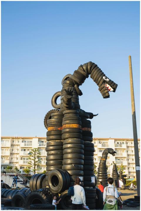 Dinosaurs with opened mouths made of pile of old t