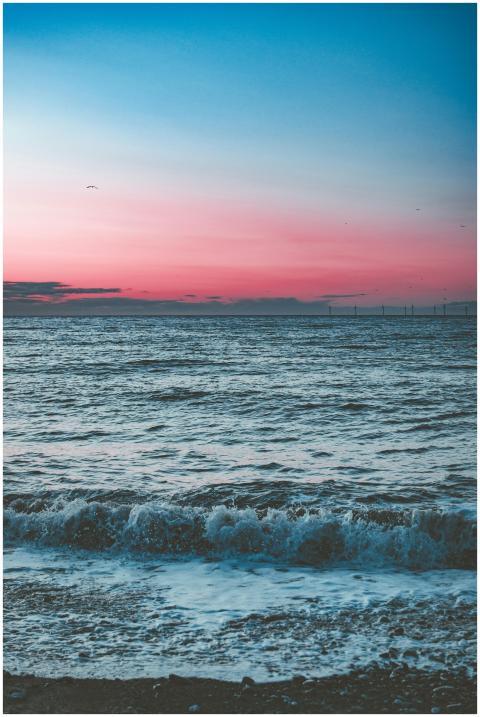 A tranquil ocean scene at dawn showcasing waves un