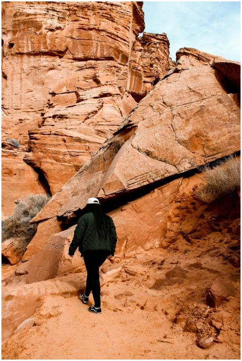A person hikes through the majestic red rock forma
