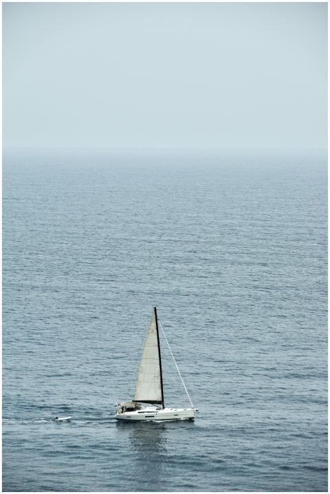 Serene image of a solitary sailboat gliding throug
