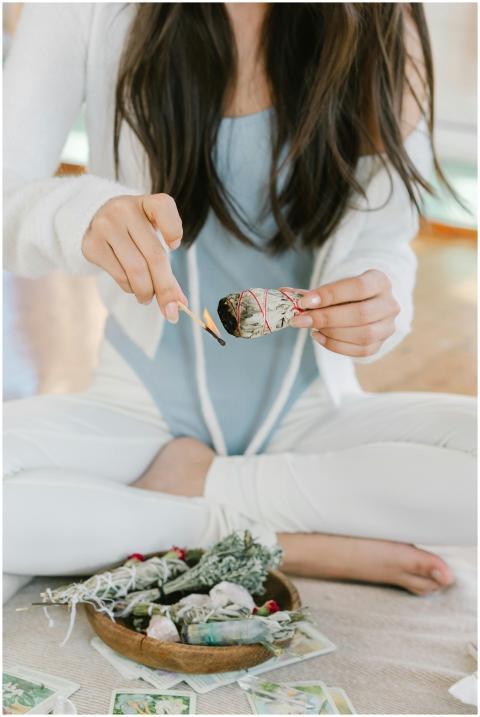 A serene scene of a woman meditating with burning