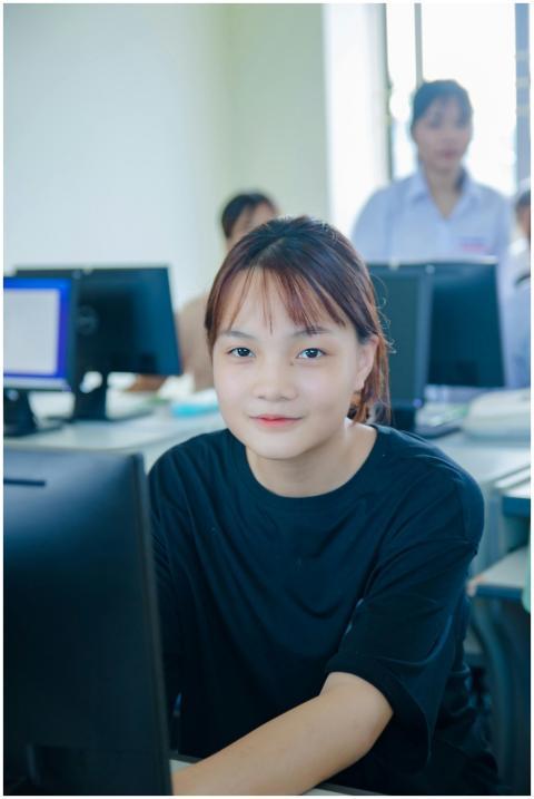Asian girl studying in a university computer lab,