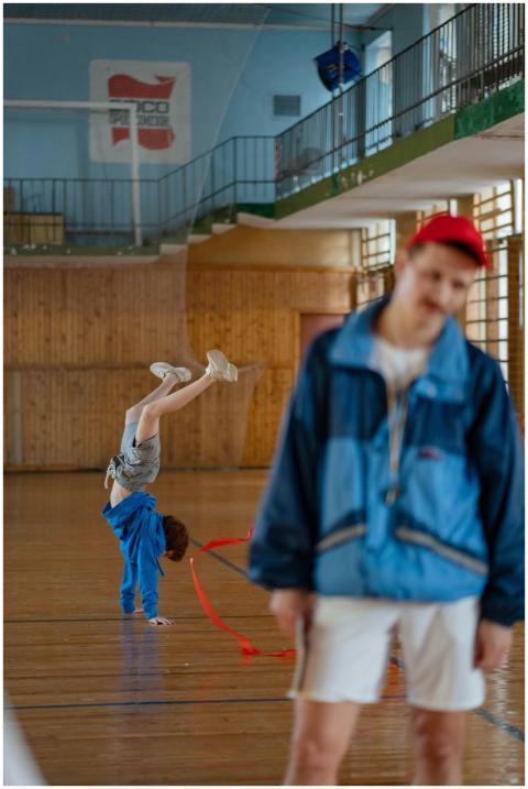 Joyful children practicing gymnastics indoors with