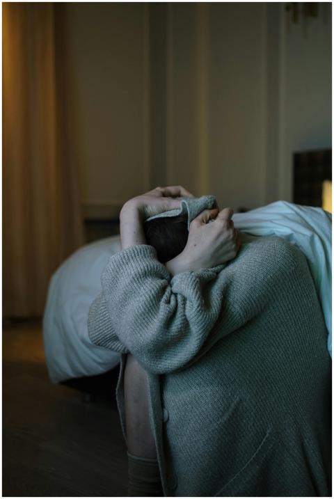 A person wrapped in a blanket, reflecting anxiety