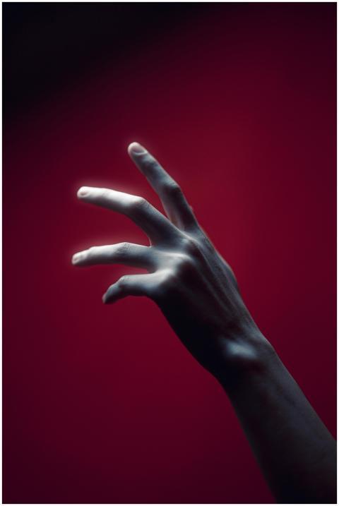 A mysterious artistic shot of a hand illuminated a