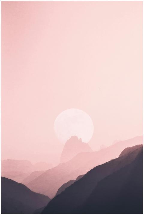 Gentle moonrise casting a soft glow over misty mou