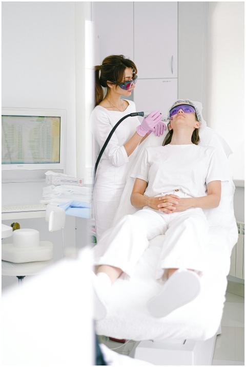 Two women in a clinic during a laser facial treatm