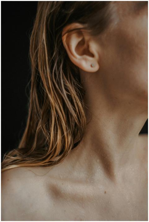 Artistic close-up portrait of a woman with wet hai