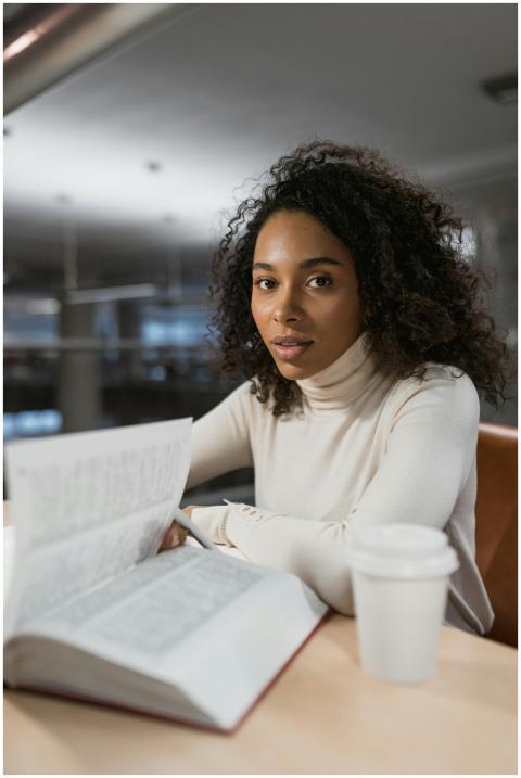 Young African American woman with curly hair readi