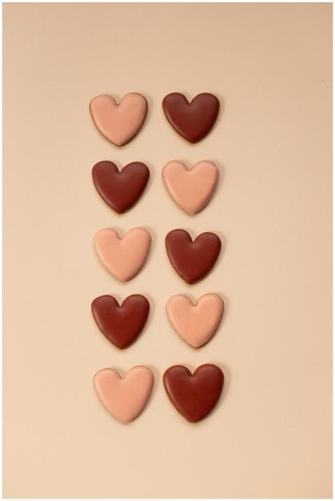 Artfully arranged heart-shaped cookies on a beige