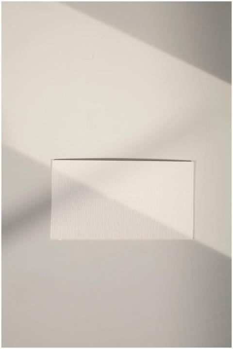 A minimalist image of a white paper placed on a te