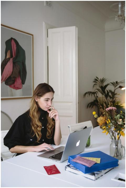 Woman working on a laptop at home, embracing digit