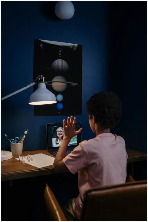 A child participates in an online class in a neatl