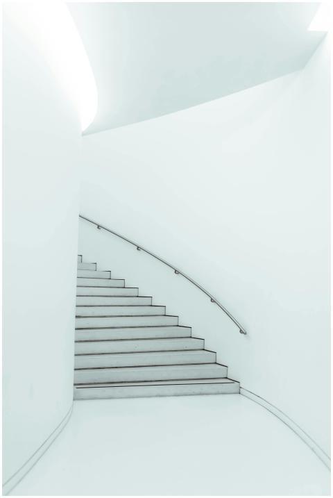 A sleek, minimalist staircase with a curved metal