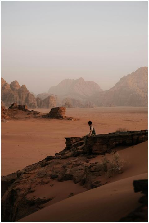 Man sitting on rock in the majestic desert landsca