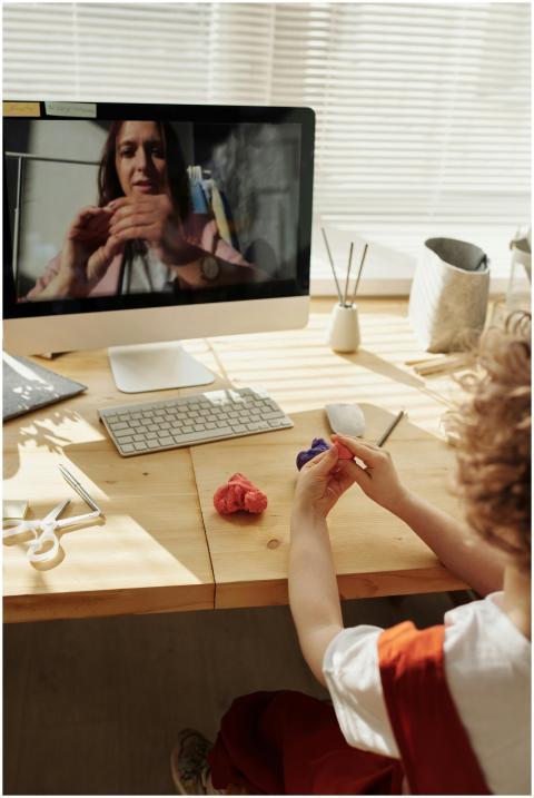 A child engaging in an online arts and crafts clas
