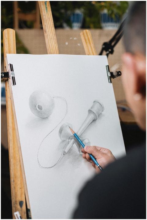 Artist sketching kendama toy on easel. Shinjuku, T