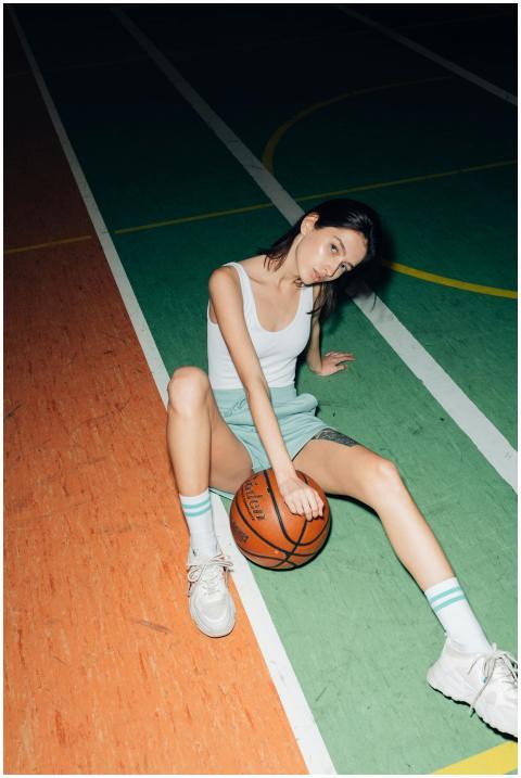 A young woman in a tank top sitting on a vibrant b