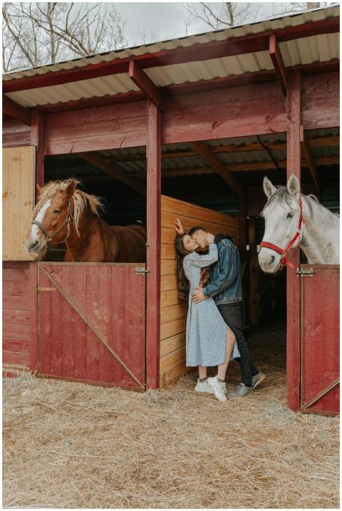 Side view of trendy man kissing and embracing girl