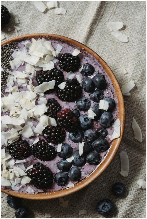 Delicious smoothie bowl topped with blackberries,