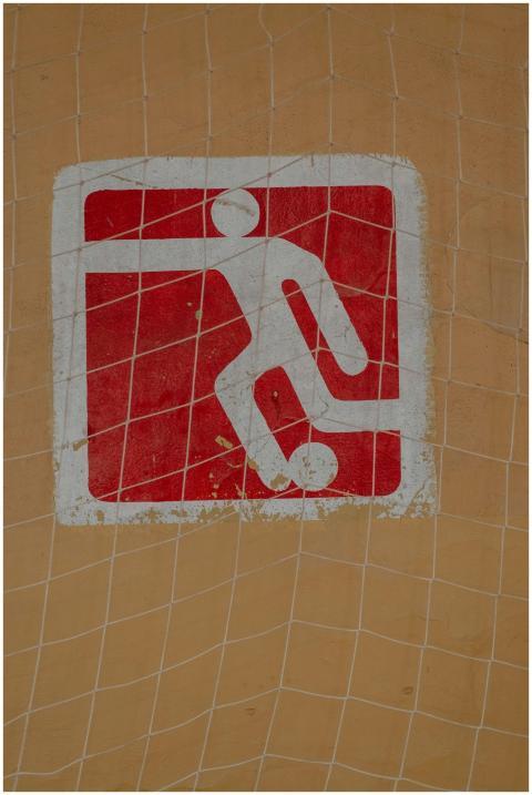 Close-up of a painted soccer symbol on a wall, cov