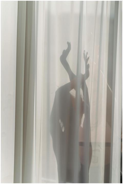 Shadow of anonymous female dancer performing sensu