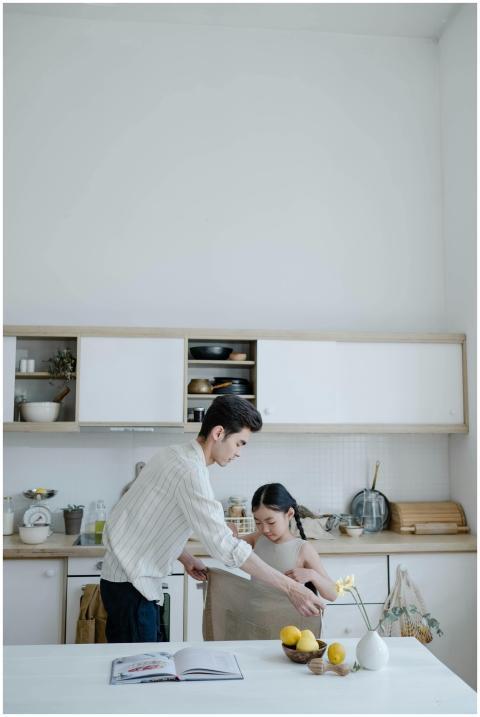 Father and daughter bonding in kitchen, preparing