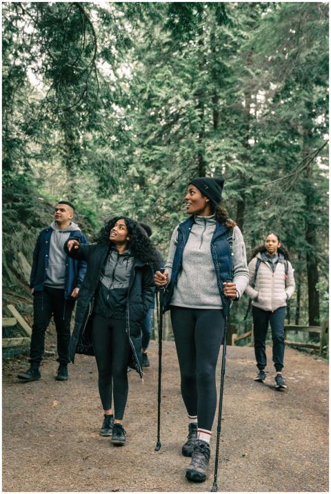 A group enjoying a hike through a lush green fores