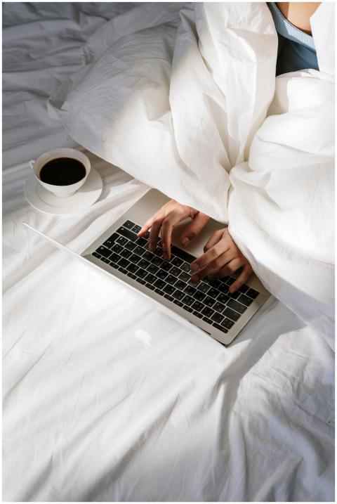 Comfortable home office setup with a laptop on bed