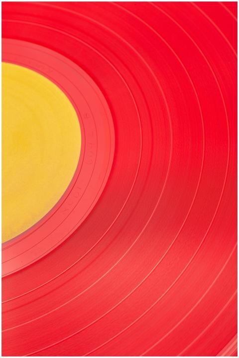 Vibrant red and yellow close-up of a vinyl record,