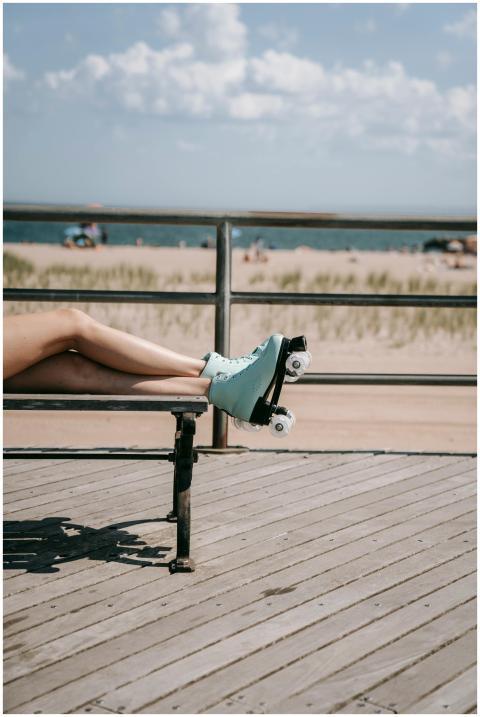 A person relaxing on a bench with roller skates at