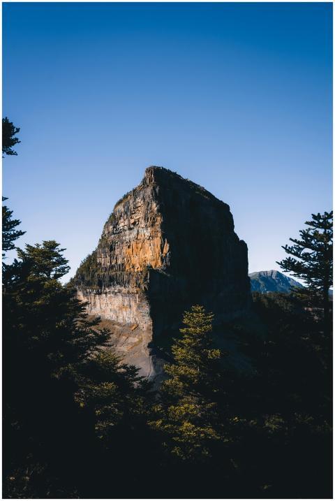 Aerial view of a majestic rock formation surrounde