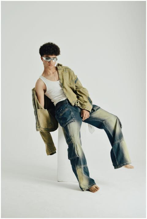 A fashion-forward young adult posing indoors weari