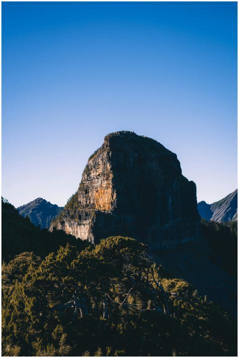 Breathtaking view of a rocky mountain peak with tr