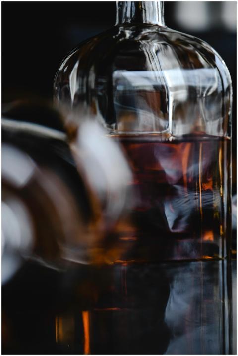 Artistic capture of a liquor bottle with reflectio